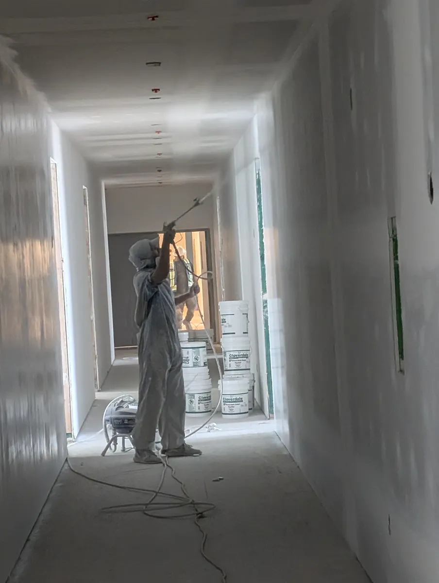 Spray-priming an apartment building, central Edmonton