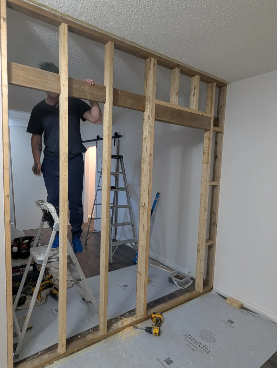 Finished basement wall addition with sliding door, West Edmonton