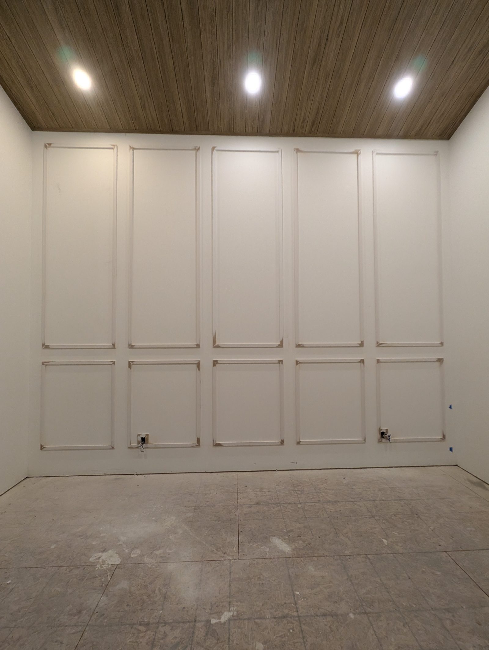 White panelled master bedroom feature wall, Windermere