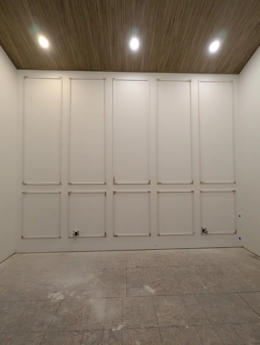 White panelled master bedroom feature wall, Windermere