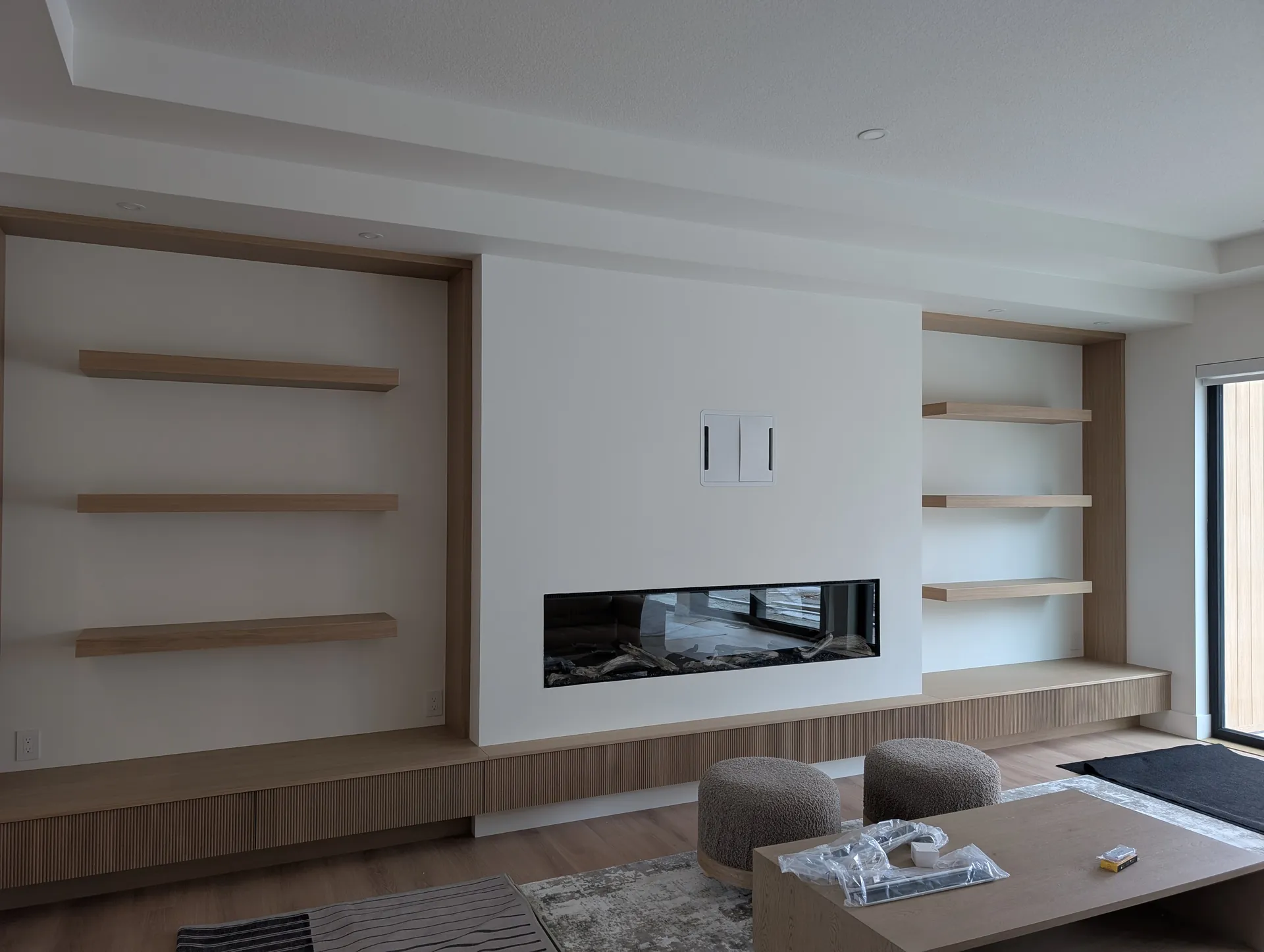 Modern living room with feature fireplace painted by Alpine in Windermere, Edmonton