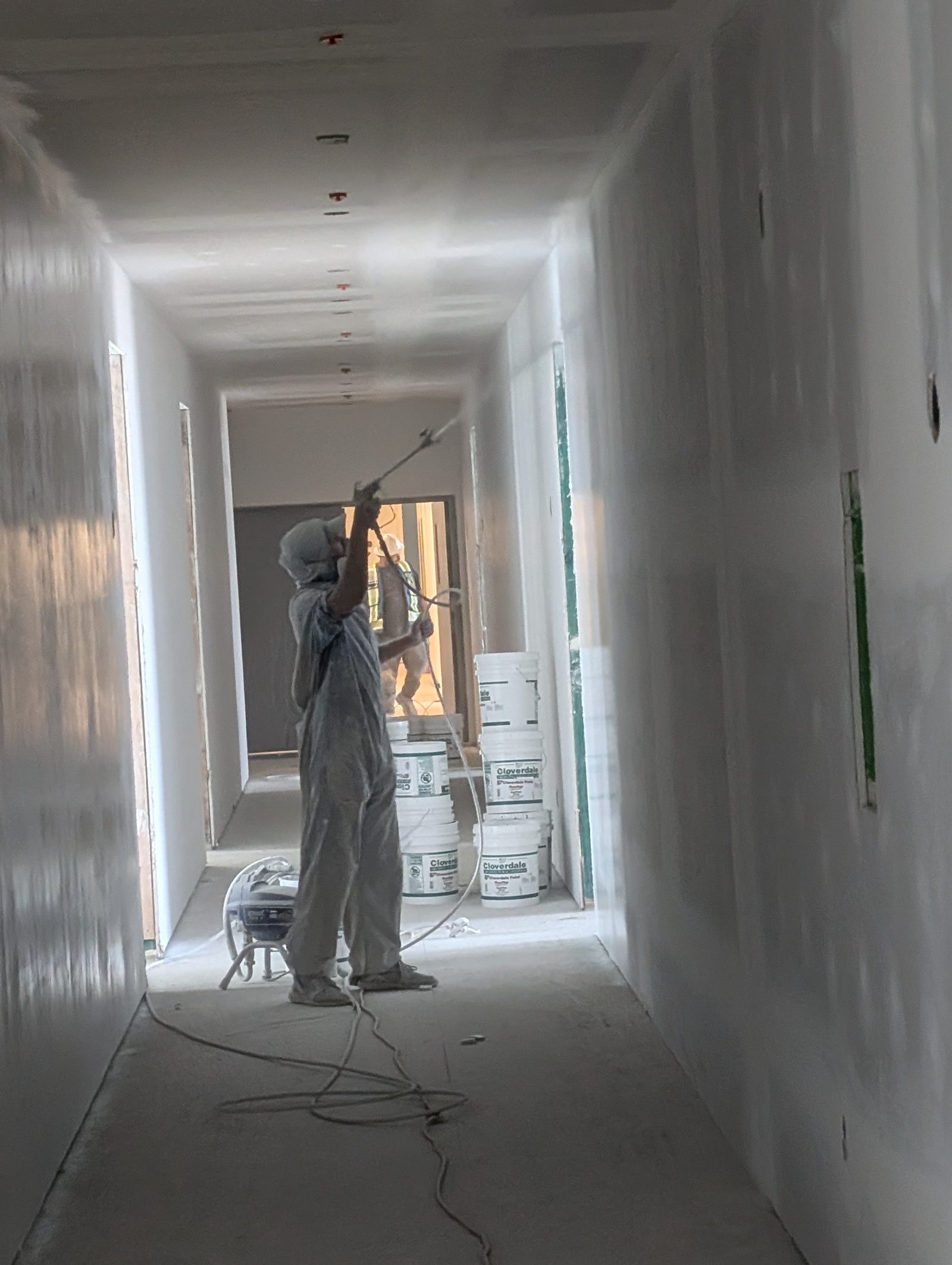 Spray-priming an apartment building, central Edmonton